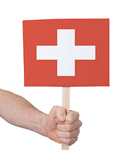 Image showing Hand holding small card - Flag of Switzerland