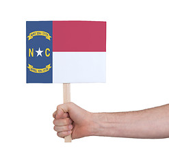 Image showing Hand holding small card - Flag of North Carolina