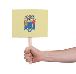 Image showing Hand holding small card - Flag of New Jersey