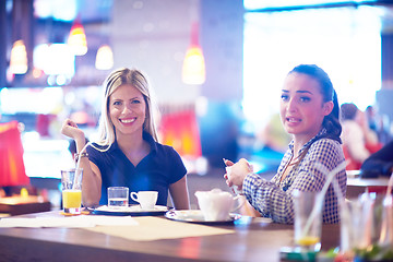 Image showing girls have cup of coffee in restaurant