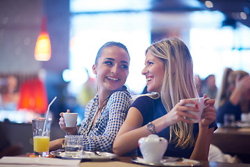 Image showing girls have cup of coffee in restaurant