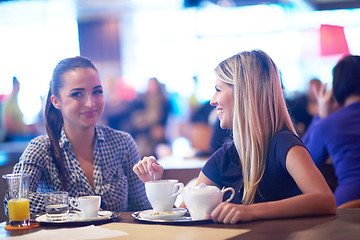 Image showing girls have cup of coffee in restaurant