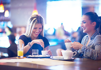 Image showing girls have cup of coffee in restaurant