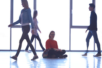 Image showing student girl standing with laptop, people group passing by