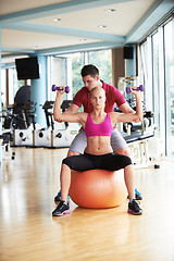 Image showing young sporty woman with trainer exercise weights lifting