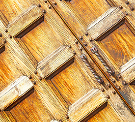 Image showing abstract texture of a brown antique wooden old door in italy eur