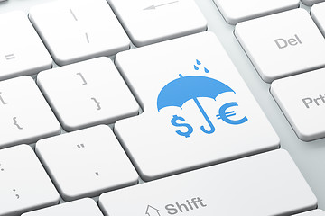 Image showing Security concept: Money And Umbrella on computer keyboard background