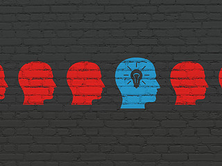 Image showing Business concept: head with light bulb icon on wall background