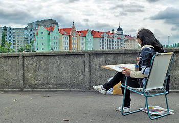 Image showing Street artist paints Fishing Village. Kaliningrad. Russia