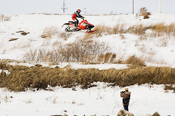 Image showing Flying of sportsman on snowmobile and press man