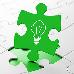 Image showing Finance concept: Light Bulb on puzzle background