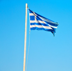 Image showing waving greece flag in the blue sky and flagpole