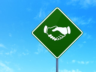 Image showing Finance concept: Handshake on road sign background