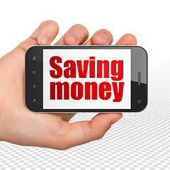 Image showing Business concept: Hand Holding Smartphone with Saving Money on display