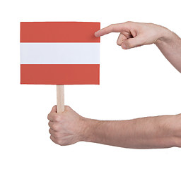 Image showing Hand holding small card - Flag of Austria