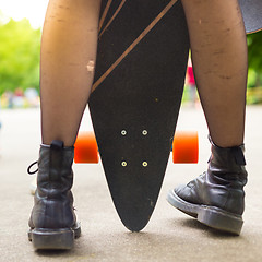 Image showing Teenage girl urban long board riding.