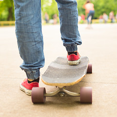 Image showing Teenage girl practicing riding long board.