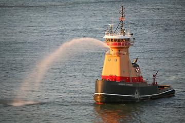 Image showing Tugboat spraying water