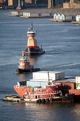 Image showing Tugboats and cargo ship in East River