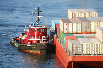 Image showing Tugboat hauling cargo ship