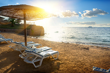 Image showing Chaise-longues on a beach