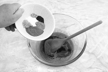 Image showing Woman adding spices to pumpkin pie filling