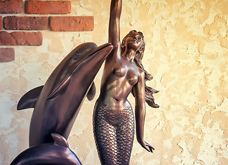 Image showing Bronze sculpture mermaids and dolphins.