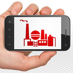 Image showing Business concept: Hand Holding Smartphone with Oil And Gas Indusry on display