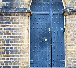 Image showing wooden parliament in london old church door and marble antique  