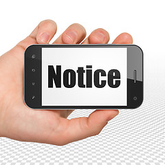 Image showing Law concept: Hand Holding Smartphone with Notice on display