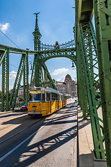 Image showing The green Freedom Bridge, with yellow tram, in Budapest,the capi