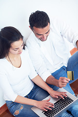 Image showing relaxed young couple working on laptop computer at home