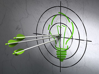 Image showing Business concept: arrows in Light Bulb target on wall background