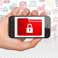 Image showing Business concept: Hand Holding Smartphone with Folder With Lock on display