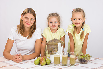 Image showing Mother and two daughters to cook for three glasses of juice juicer