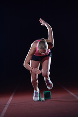 Image showing pixelated design of woman  sprinter leaving starting blocks