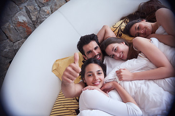 Image showing handsome man in bed with three beautiful woman