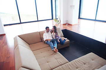 Image showing relaxed young couple working on laptop computer at home