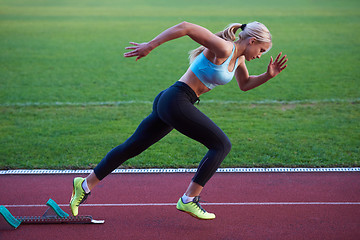 Image showing pixelated design of woman  sprinter leaving starting blocks