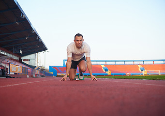 Image showing pixelated design of woman  sprinter leaving starting blocks