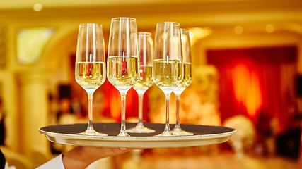 Image showing Waiter serving champagne on a tray