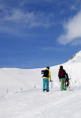 Image showing Snowboarders on slope at sun nice day