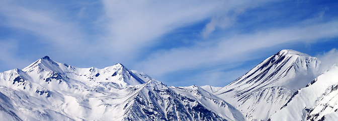 Image showing Panoramic view on winter snowy mountains in windy day