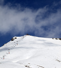 Image showing Ski slope and ropeway at sunny winter day