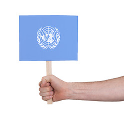 Image showing Hand holding small card - Flag of the UN