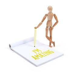 Image showing Wooden mannequin writing - I\'m amazing