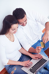 Image showing relaxed young couple working on laptop computer at home