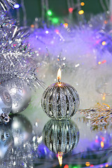 Image showing Christmas decorations with candle and silver balls.