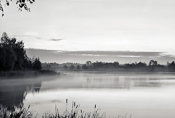 Image showing The morning landscape with sunrise over water in the fog. Black 