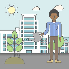 Image showing Man watering tree.